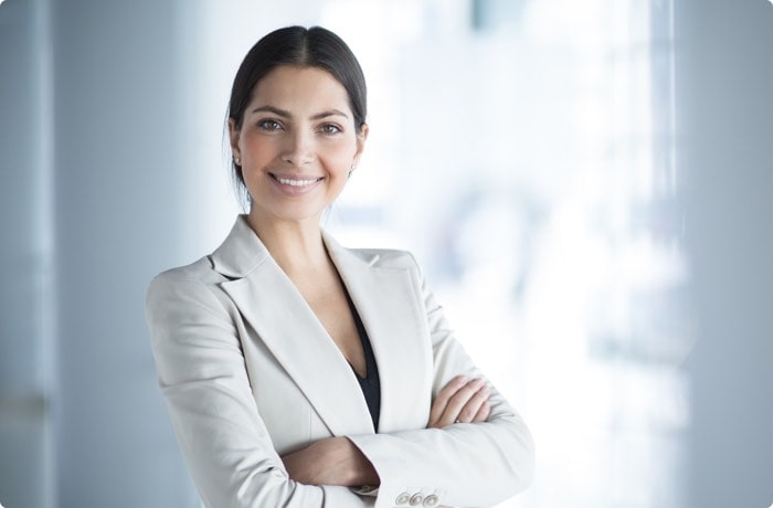 female insurance broker in light coloured suit