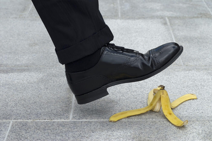 close up of an office worker walking about to slip on banana peel