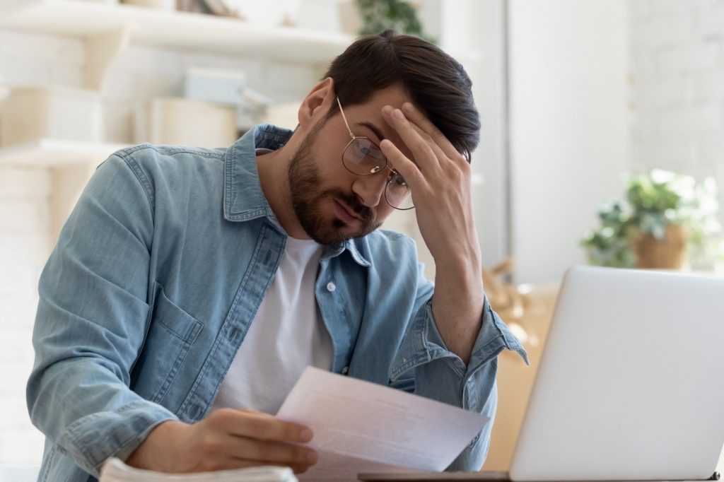 man looking at paperwork