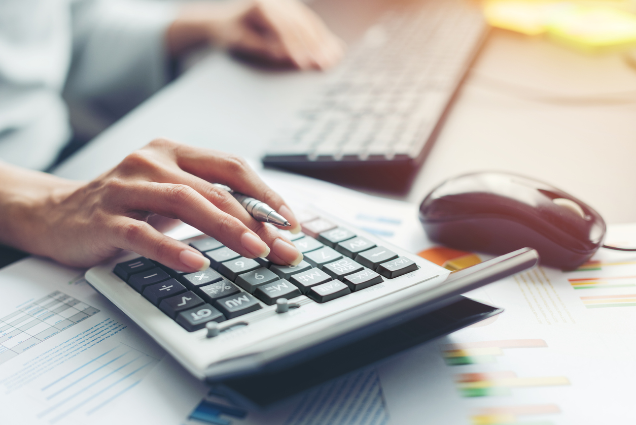 hand of business woman accountant or banker making calculations.