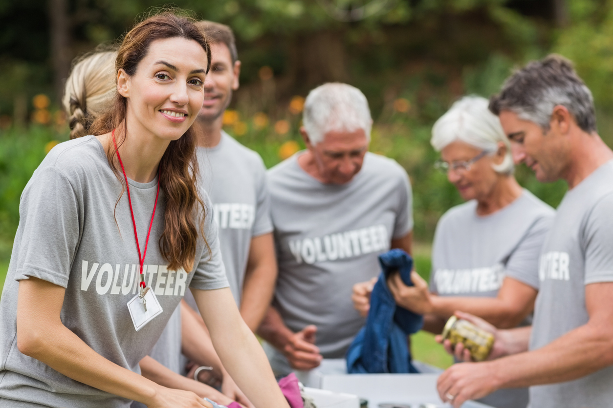 Happy volunteer looking at donation box