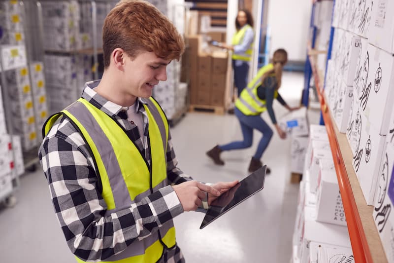 young man learning warehouse job